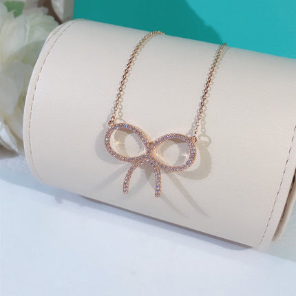 CLAW SET RHODIUM PLATED BOW NECKLACE